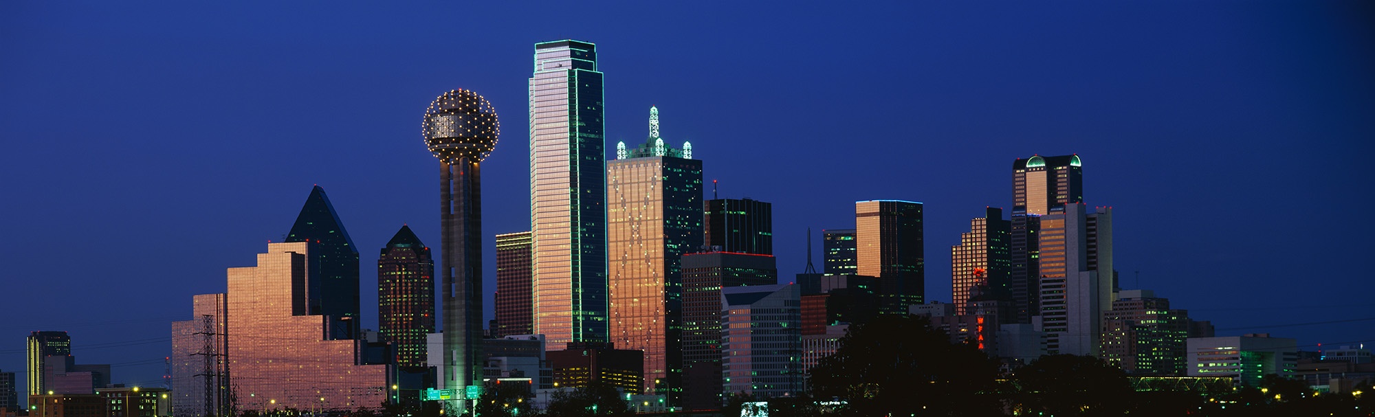This is the skyline at dusk. It shows the Reunion Tower which is 50 stories high.